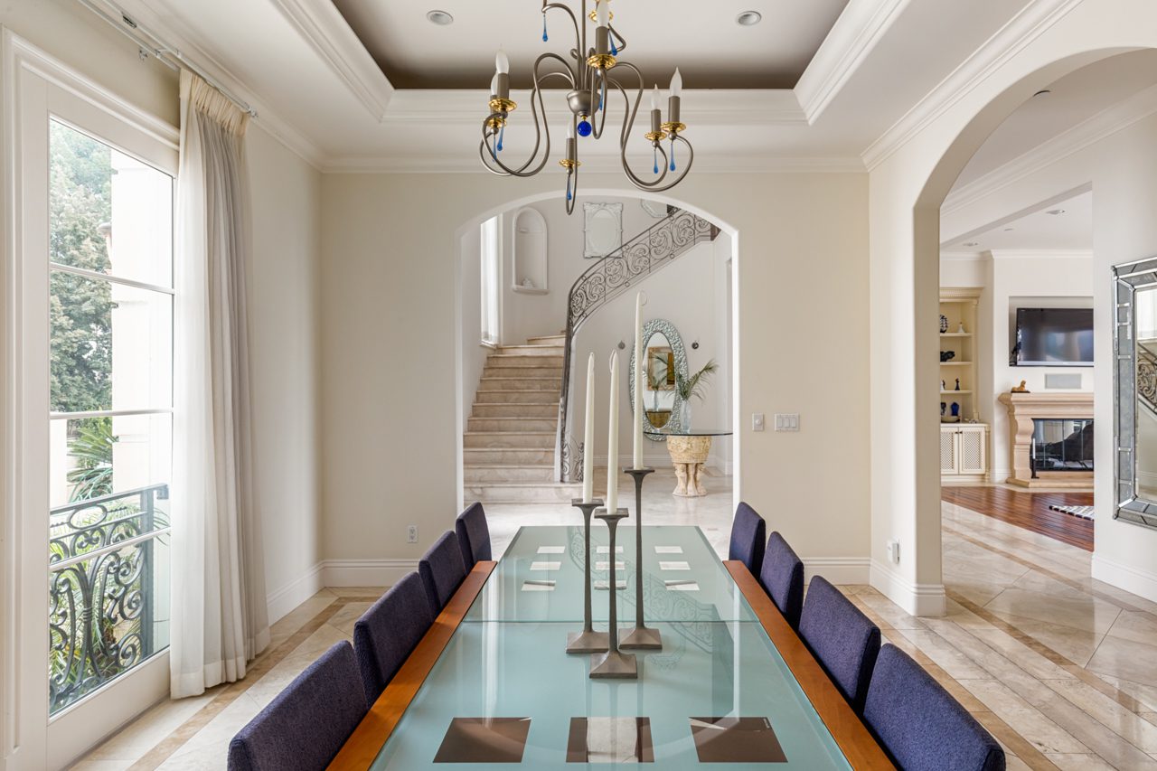 A long table with blue chairs in the middle of it